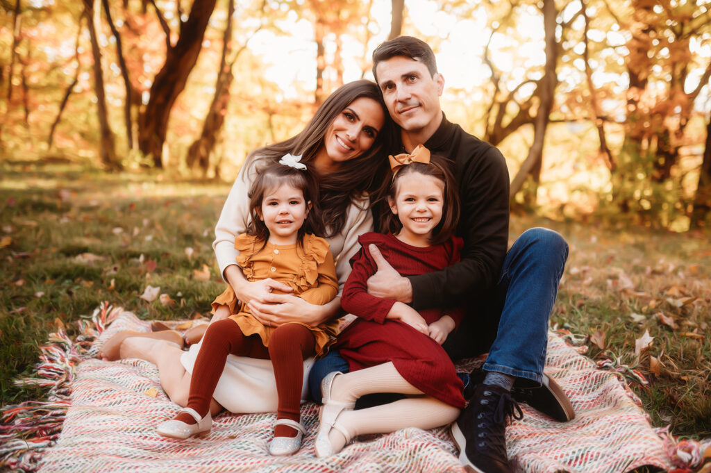 Parents snuggle their children during Fall Family Photos on the Blue Ridge Parkway in Asheville, NC.