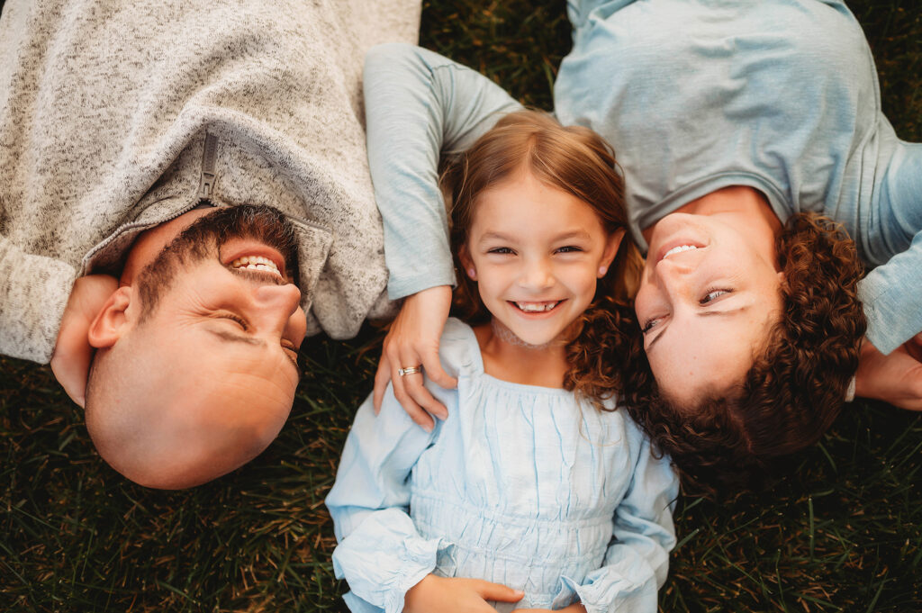 Parents embrace their daughter during Family Photoshoot in Asheville, NC.