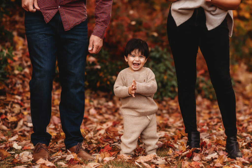 Baby giggles and claps during Family Portrait Session in the Fall on the Blue Ridge Parkway in Asheville, NC after visiting the Top 5 Must Visit Playgrounds in Asheville, NC.