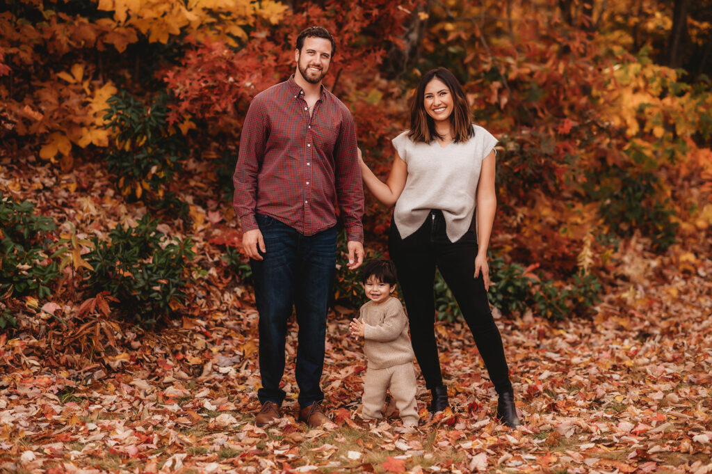 Baby giggles and claps during Family Portrait Session in the Fall on the Blue Ridge Parkway in Asheville, NC after visiting the Top 5 Must Visit Playgrounds in Asheville, NC.