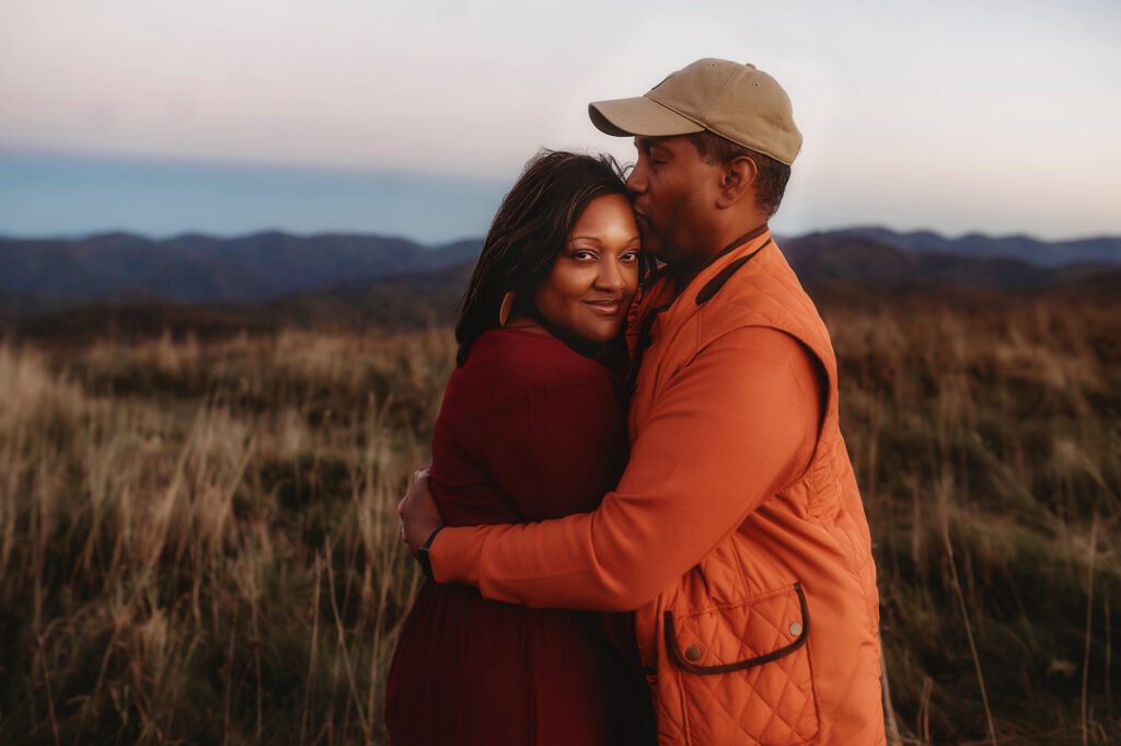 Husband kisses wife during Family Photoshoot at Max Patch. 