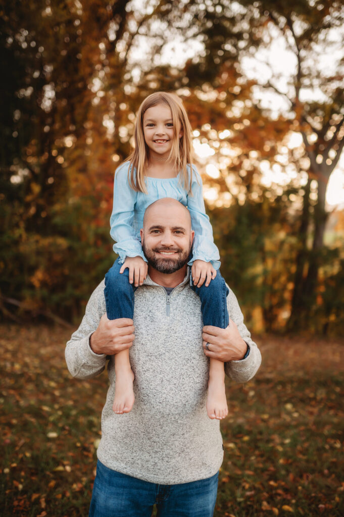 Father holds his daughter on his shoulders for Family Photos in Asheville. 