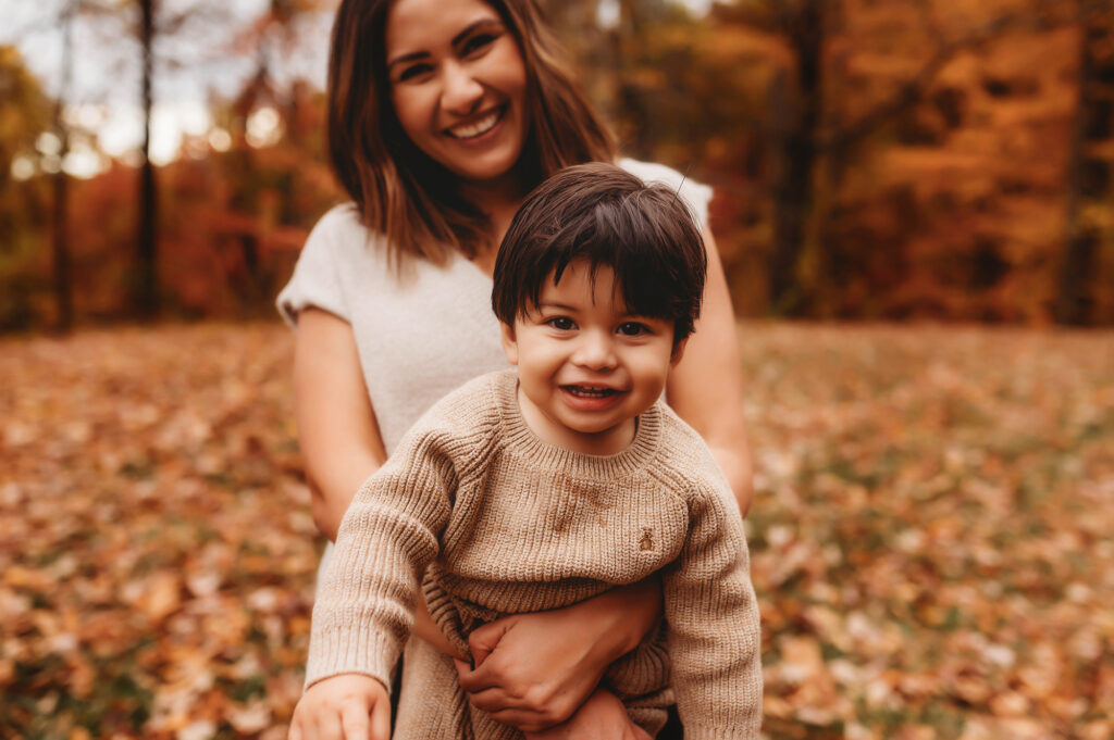 Mother embraces her toddler during Family Portrait Session on the Blue Ridge Parkway in Asheville, NC.