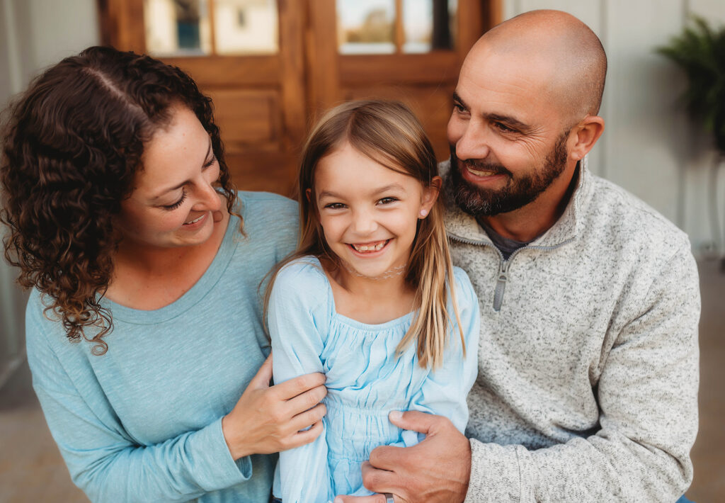 Parents snuggle with their daughter during Family Photo Locations in Asheville. 