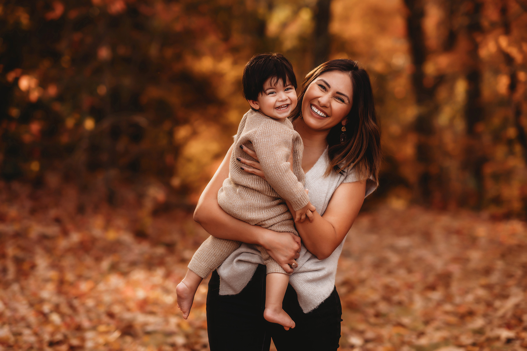 Mother embraces her toddler during Family Photoshoot on the Blue Ridge Parkway in Asheville, NC after learning about the Top 5 Must Visit Playgrounds in Asheville, NC.