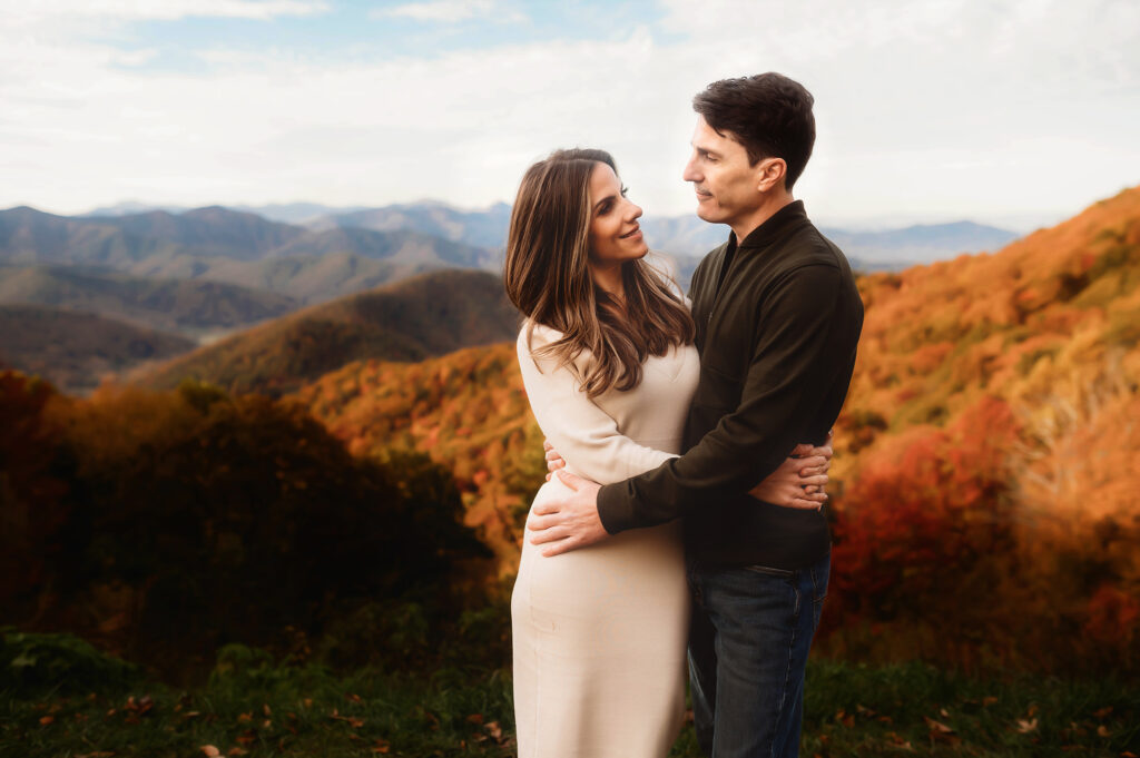 Husband and Wife embrace during Fall Family Photos on the Blue Ridge Parkway in Asheville, NC.