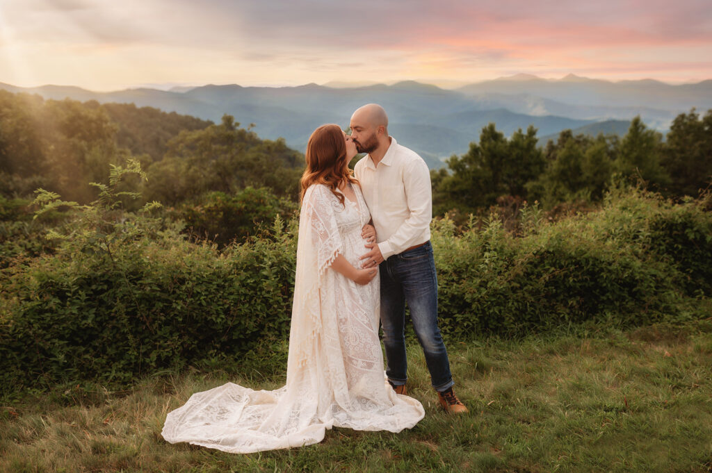 Expectant parents kiss during their Blue Ridge Parkway Maternity Photoshoot.