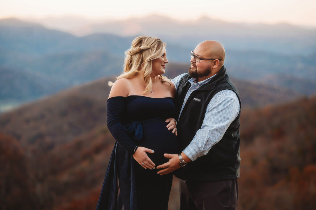 Husband and wife embrace during Maternity Portrait Session in Asheville. 