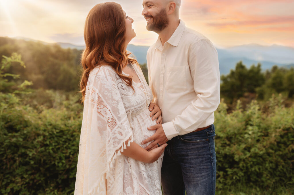 Expectant parents pose for Maternity Photos on the Blue Ridge Parkway in Asheville, NC after learning about the 5 Fun Things Pregnant Women Should Experience in Asheville.