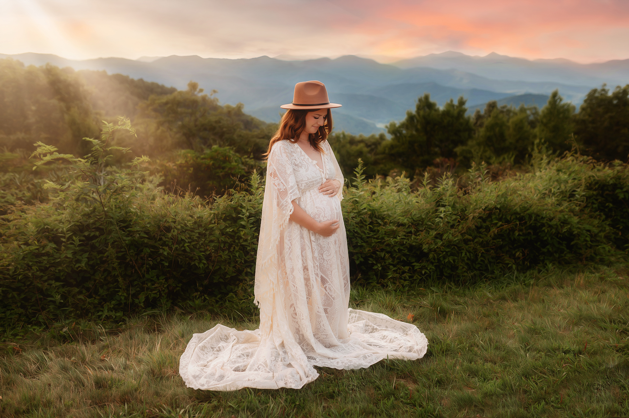 Expectant mother embraces her pregnant belly during Maternity Portrait Session on the Blue Ridge Parkway in Asheville, NC.