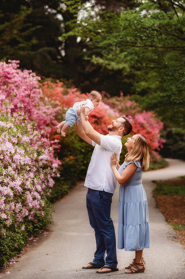 Parents embrace their baby during Family Photos at Biltmore Estate in the Spring. 